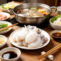 Boiled baby cuttlefish in hot pot broth with vegetables