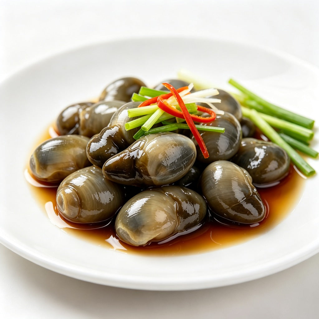 Marinated mud snails garnished with sliced chilli and spring onion